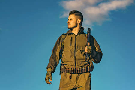 Hunter with shotgun gun on hunt. Hunter in the fall hunting season.