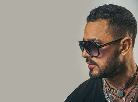 Fashion male model in sunglasses. Sexy man isolated on grey background isolated.の写真素材