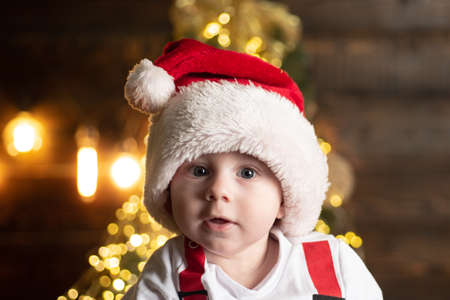 Amazed attractive baby in Christmas costume, close up face.の写真素材