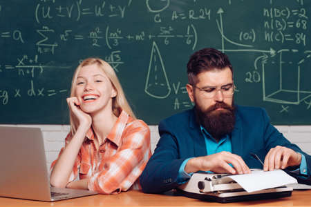 Back to school. Team collaboration concept. Teacher helping his students with math or mathematics on...
