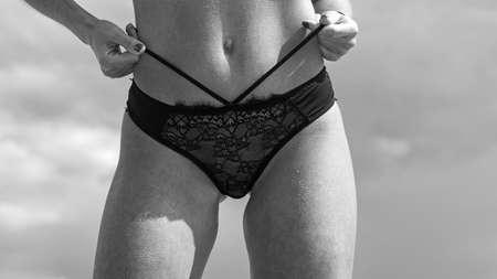 Sexy female ass in luxury panties. Happy young woman having fun at beach on sunny day. Perfect young girl ass in sexy panties. Relax in spa.の写真素材