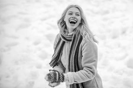 Cute playful young woman outdoor enjoying first snow. Portrait of a happy woman in the winter. Cheerful girl outdoors. Winter woman.の写真素材