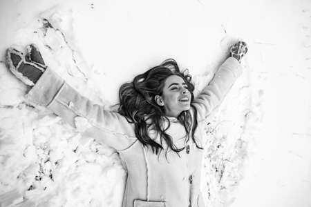 Girl playing with snow in park. What happens during winter season. Global cooling.