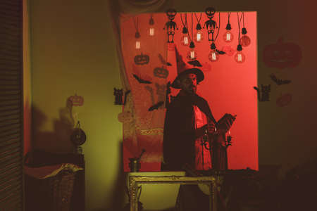 31 october. Make up and scary concept for man. Celebration party. Funny wise wizard on a Halloween background. Halloween, holidays celebration.の写真素材