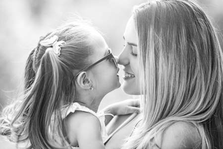 Family generation and people concept. Close-up portrait of smiling mother hugging cute little...