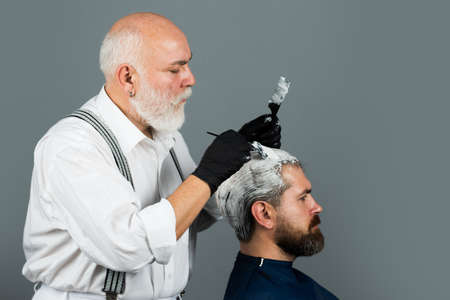 Hair coloring man. Barber make a coloring haircut.の写真素材