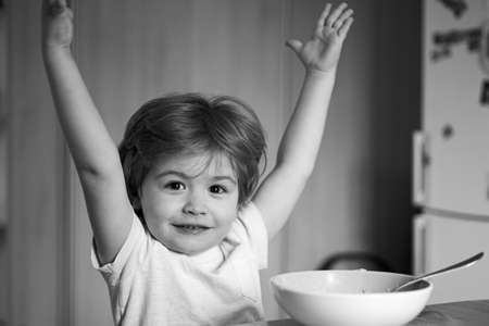 Excited little boy - ecology Food concept. Happy child have a breakfast. Portrait of sweet little...