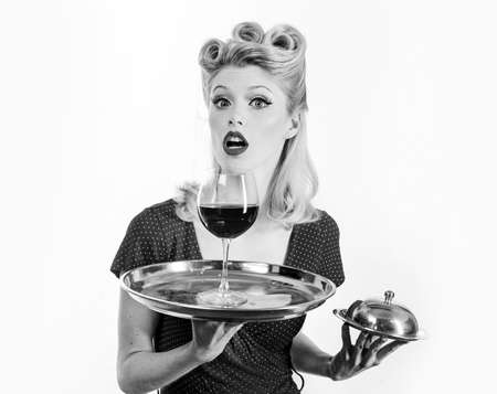 Happy girl with glass of wine. Red lips. Woman studio photography. Beauty. Happy excited woman in retro dress with beautiful hairdo. Fashion.の写真素材