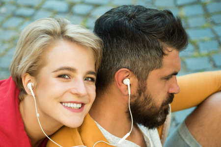 Man and woman modern clothes for youth relaxing outdoors. Couple hang out together. Youth just want have fun. Freedom feeling. Forever young. Youth fashion. Enjoying music. Feeling free and stylishの写真素材