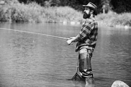 Man fishing on the lake. Hobby for soul. Man fisherman catches a fish. Ready for fishing. Man...