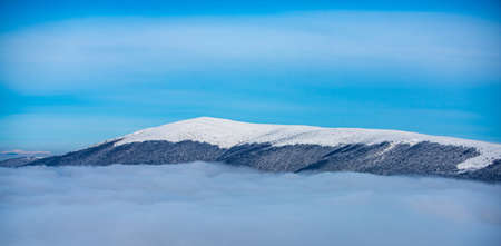 Panorama of snowy mountains. Winter forest landscape with snow and blue sky.の写真素材