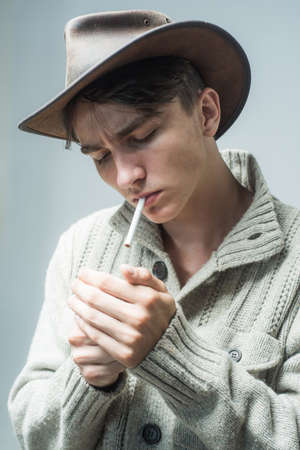 Man smoking cigar. Handsome man wear cowboy hat.の写真素材