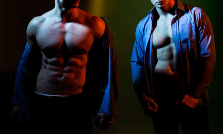 Sexy gays with muscle. Strong, naked torsos, chests, bellies, six packs, abs, arms in blue shirt.の写真素材