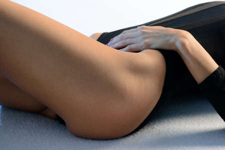 Women health. Beautiful healthy woman with fit slim body, black underwear. Body stomach care.