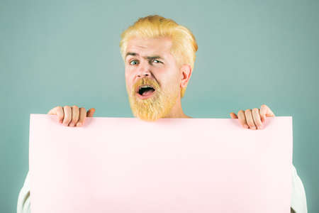 Excited man holding empty blank board. Your text here.