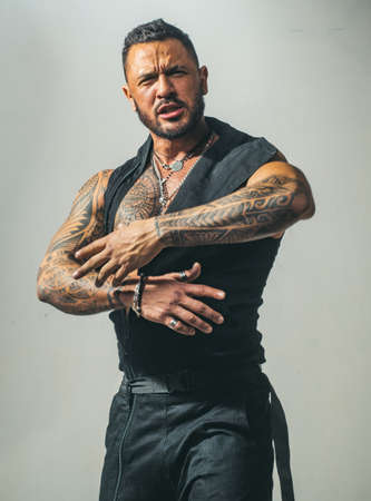 Studio shot of young man looking at the camera. Handsome guy with confident face.