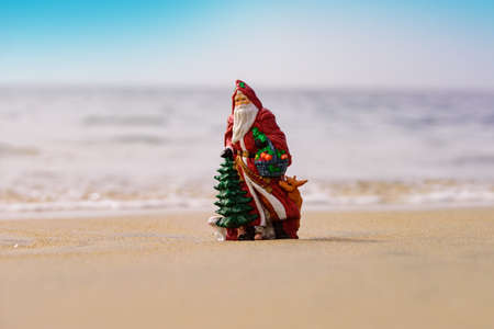 Summer Santa on sand. Xmas card. Holiday concept for New Year and Christmas.の写真素材