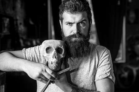 Hair salon and barber vintage. Barber making haircut of attractive bearded man in barber shop. Barber shop design. Barbershop vintage. Bearded man or hipster. Portrait bearded man.の写真素材