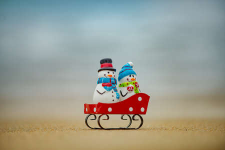 Funny toy snowman. Tropical Christmas. New year vacation on tropical beach.の写真素材