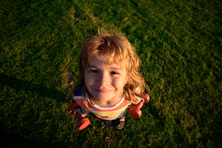 Fun child faces. Funny child with dumbbells. Children health concept. Outside.の写真素材