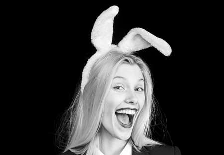 Sexy model dressed in costume Easter bunny. Egg hunt. Sexy woman with mask Easter bunny on a black background and looks very sensually. Easter dinner menu. Blonde woman in rabbit bunny ears.の写真素材
