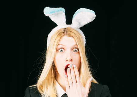 model dressed in costume Easter bunny. Woman rabbit easter bunny girl. Fashion studio photo   beautiful girl with blond hair with bunny ears. Surprise.の写真素材