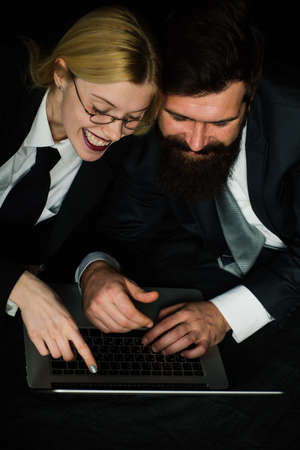 Caucasian businessman and businesswoman working on laptop notebook computer with relax and happiness...