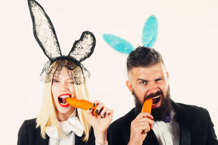 Beautiful young woman with bunny ears and blank poster on color background. Ready for the party. Happy Easterの写真素材