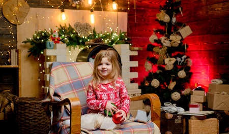 Believe in christmas miracle. Wish to meet santa claus. Winter holidays. Merry christmas and happy new year. Happy childhood. Adorable child play at home. Dreamy baby toddler on christmas eveの写真素材