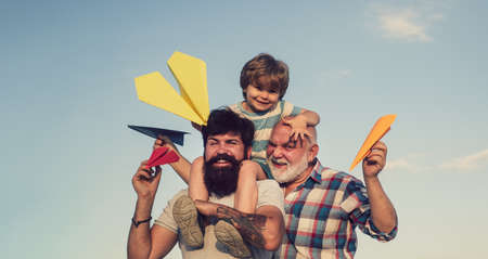 Weekend family play. Men in different ages. Happy men loving family. Father son and grandfather playing - family time together. Happy fathers day.の写真素材