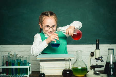 They carried out a new experiment in chemistry. Happy little scientist making experiment with test tube. Back to school. Back to school and home schooling.の写真素材