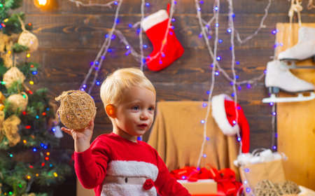 Merry Christmas and Happy Holidays. Happy child with christmas gift box. Christmas story concept. The morning before Xmasの写真素材