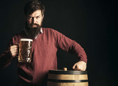 Man with beer. Beer in the UK. Beer Types and Styles. Germany Bavaria. Bearded man drinking lager beer.の写真素材