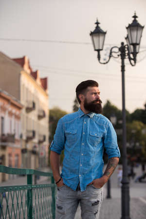 Portrait of handsome man on street. Fashion guy looking at camera, outdoor city.の写真素材
