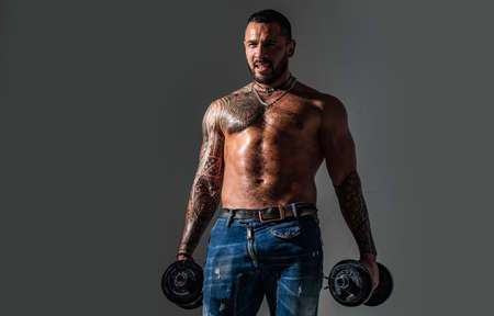 Muscular sexy man naked torso with dumbbell.の写真素材
