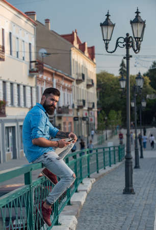 Hipster man texting on the mobile phone.の写真素材