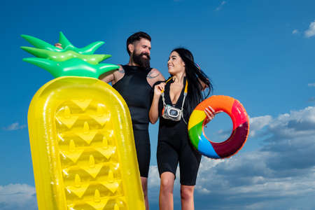 Sexy couple on beach. Happy couple drinking cocktail on summer at the beach. Summertime. Happy...