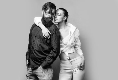 Young sexy couple in studio on grey background.の写真素材