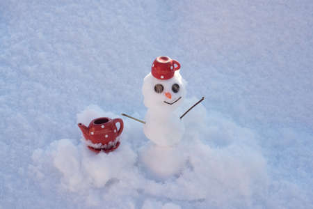 Tea or coffee break. Little snowman with coffee tea cup. Snowy weather.の写真素材