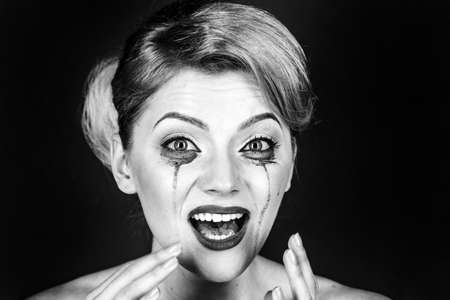 Woman drama and shock concept. Girl cry with mascara streams on face. Woman with shocked face with...