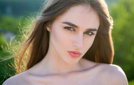 Spring natural beauty. Bare shoulders woman. Summertime girl outdoor. Closeup teen face.の写真素材