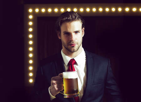 Man businessman hold beer glass, bar and restaurant, tasting and degustation beers.の写真素材