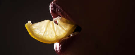 Lips with lemons. Vitamin C. Summer refreshment concept. Banner.の写真素材