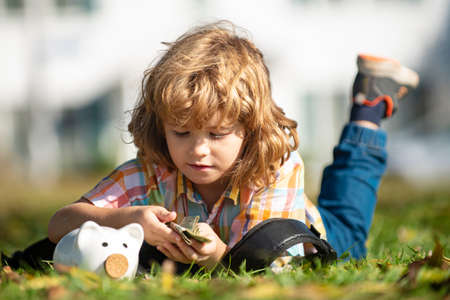Piggy bank investments. Saving money. Child with dollars. Banking and Finance.の写真素材