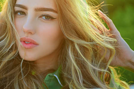Closeup sunny portrait girl outdoor. Natural makeup. Seasonal fashion woman. Beauty and care.の写真素材