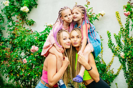 Sister family having fun outdoor. Cute positive best friend pretty young girls, spring time, hugs.