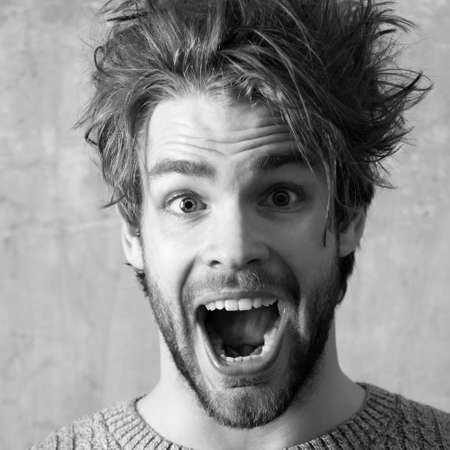 Funny excited man with open Screaming nouth, close up. Young sexy man or handsome caucasian guy...