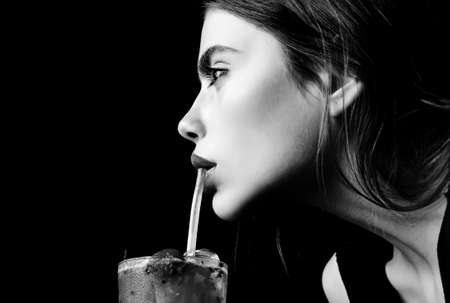 Closeup woman with cocktail on black. Concept of luxury holiday time.の写真素材