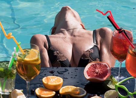 Sexy woman with refresh alcohol in pool on Maldives.の写真素材