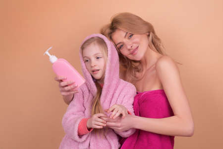 Kids hygiene equipment. Bath time. Mother with daughter in bathroom. Liquid Soap, Accessorizes for...